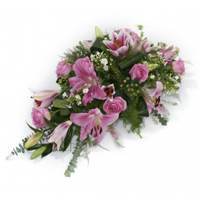 Deep Pink Spray - A spray of flowers in shades of pink.

Your florist will make you a beautiful arrangement called a “spray”, the freshest flowers of the season arranged into florist foam. The foam holds water meaning that your tribute will arrive at its destination in perfect condition. The shape is roughly a teardrop shape, tapering to a point at one end. This is a traditional and natural looking display, where the flower stems are left that little bit longer than on say a wreath or posy.

Many varieties of flowers can be used, often including oriental lilies, longi lilies, lizianthus, roses, carnations, spray carnations, statice, wax flower, september flower, solidago, eryngium, hypericum berries, eucalyptus, ruscus, parviola, leather leaf, aspidistra leaves, palm leaves, twigs, pussy willow and bere grass strands.

For this tribute, mainly pink lilies, roses and carnations will be used.