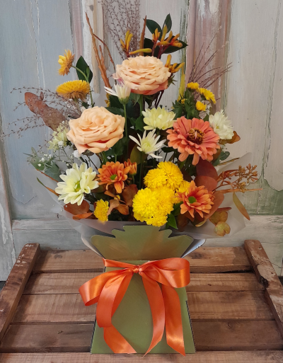 Rust and Gold Box Arrangement - This lovely gift is created with cheerful, Autumn flowers and arranged by the florist in water containing foam, making it easy to look after and enjoy for a couple of weeks. Often included are roses, lisianthus, chrysanthemums, spray carnations, freesia and berries, plus also grasses and twigs giving it a pretty Autumn feel.